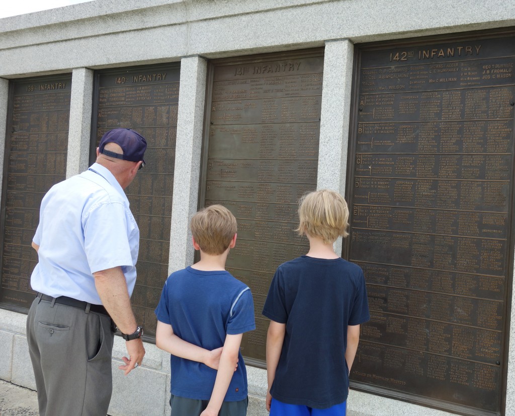 Looking at the names on the monument.
